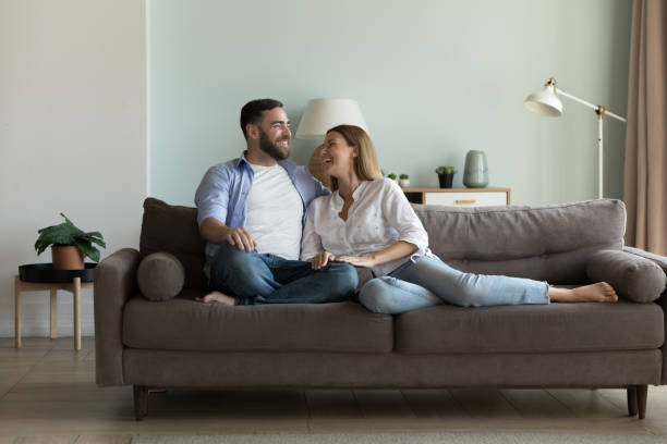 istock Happy joyful married couple resting on comfortable couch together 2194098002