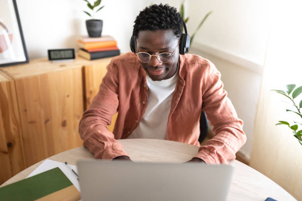 istock Young man working from home attending online meeting using laptop and headphones 2194098875