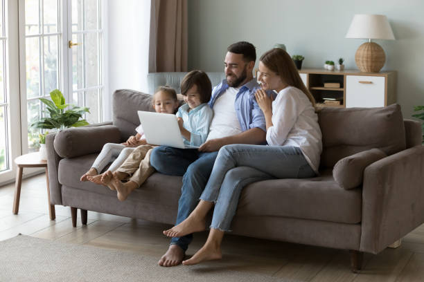 istock Happy parents and two little gen Z resting on sofa 2194099551