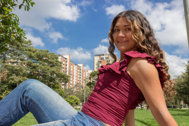 istock Beautiful young woman posing in a public park 2194100390