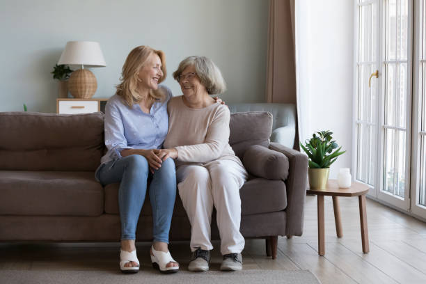 istock Happy mature grownup daughter visiting elderly mom, enjoying home 2194102221