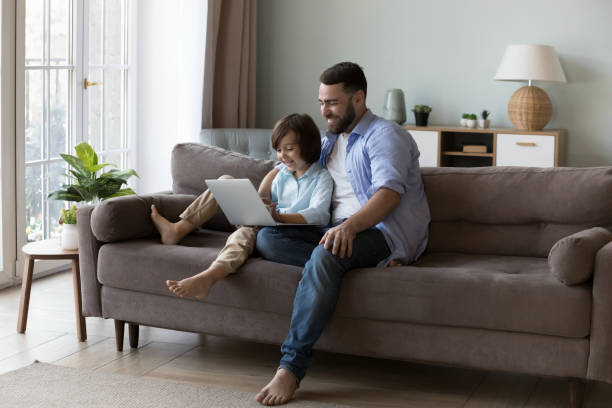 istock Happy millennial father hugging curious gen Z son kid 2194103011