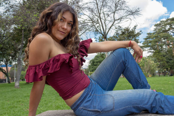istock Beautiful young woman posing in a public park 2194105434
