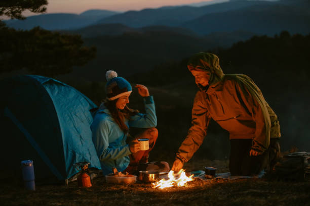 istock mom and daughter setting the campfire 2194108698