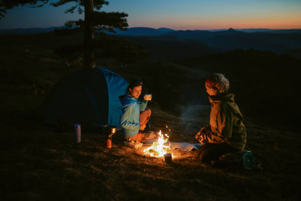 istock mom and daughter setting the campfire 2194109225