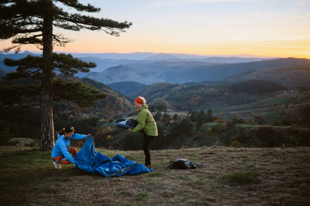 istock mom and daughter setting up a camp 2194109234