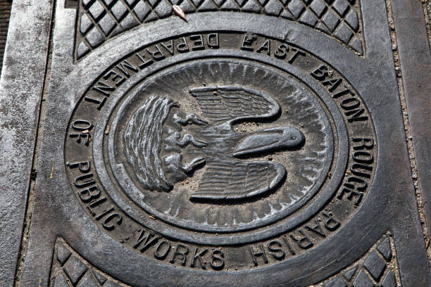 A close-up shot of a detailed manhole cover from the Department of Public Works in East Baton Rouge Parish.