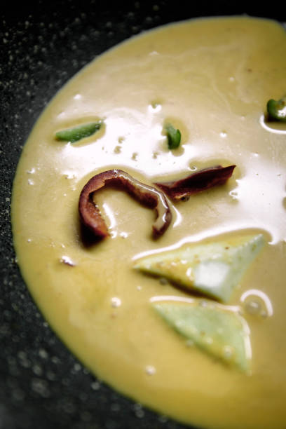 Close-up of authentic Thai green curry with rich creamy sauce, Featuring mushrooms, green chilies, And tender vegetables in a vibrant flavorful dish
