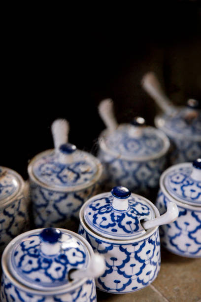 istock Close-up of traditional blue and white patterned ceramic jars with lids and spoons, showcasing intricate design and cultural craftsmanship in a rustic setting 2194114865