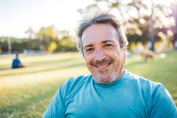 istock Smiling man in a park during a sunny and cheerful day looking at the camera 2194117025