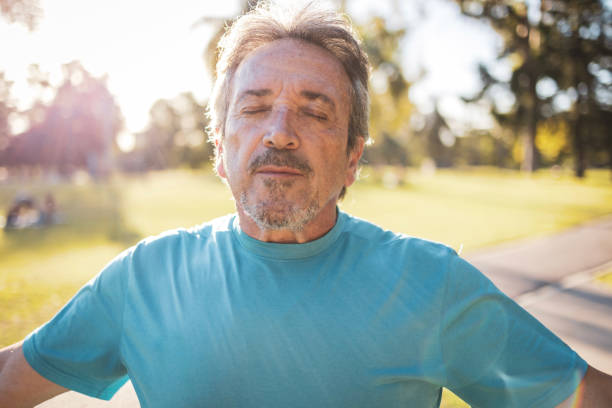 istock Man enjoying a peaceful moment outdoors in a sunny green park 2194117034