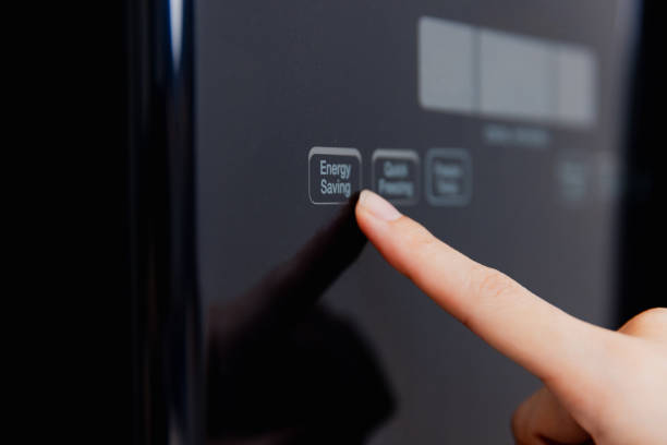 istock Energy-efficient appliance usage with focus on energy saving feature in a modern kitchen setting 2194125718