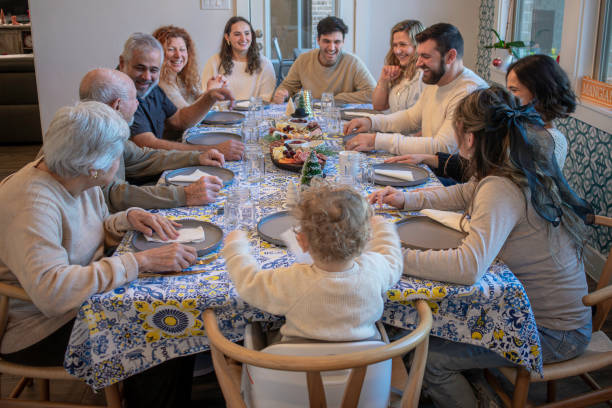 istock Multigenerational family sits and laughs at the dinning table 2194131270