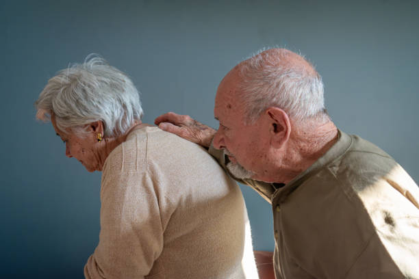 Woman (with Dementia) leads husband (care giver) out of room