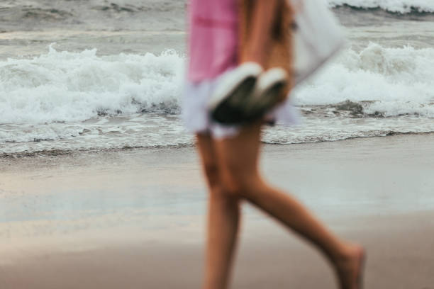 A woman is walking on beach after swimming.Canggu beach - Bali Island - Indonesia.