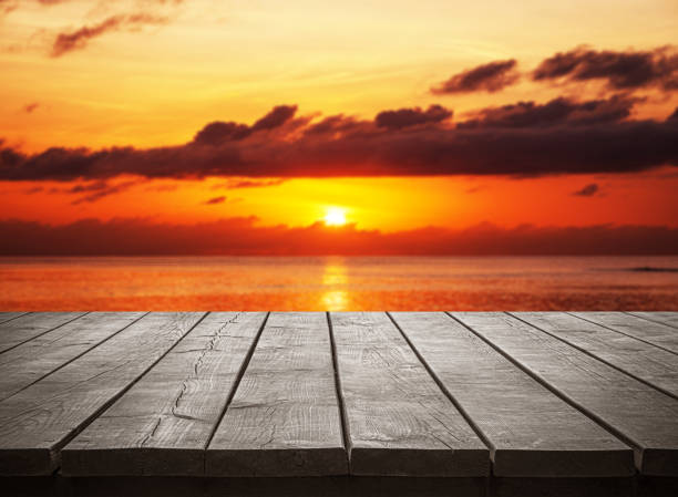 istock Empty wooden table top with tropical ocean sunset background 2194135407