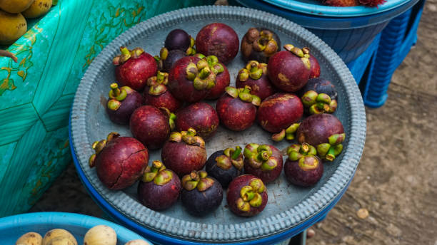 istock Fresh Mangosteens at Market Stall 2194137174