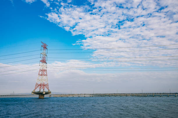 istock Offshore high voltage power towers and solar panels on the sea 2194139253