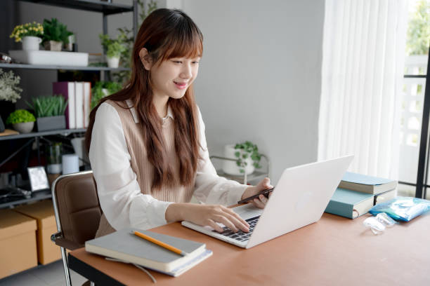istock Asian woman using laptop to study student engaged in online learning at college 2194139973