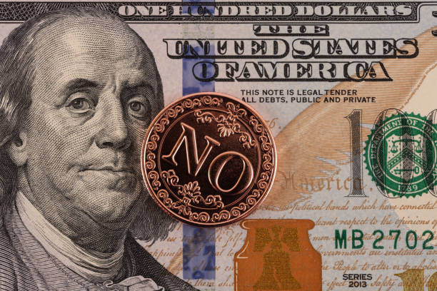 istock Coin with the inscription NO and a 100 US dollar bill 2194140599
