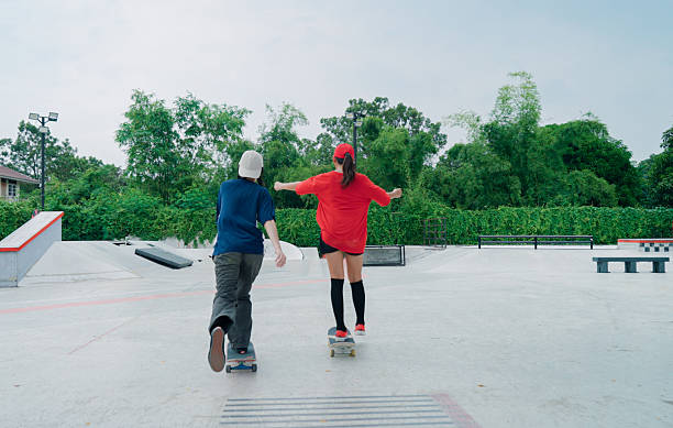 Men, skateboard and skating jump at park with balance, fitness and practice action trick for sports competition. Flare, skater and people training for performance, recreation or adventure with talent
