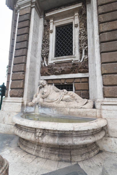 This detailed shot captures the Fontana della Dea Roma, a beautifully sculpted fountain featuring the reclining figure of the Goddess Roma. Located near Piazza del Campidoglio, the intricate stone carvings and the serene flow of water emphasize the elegance of Renaissance craftsmanship. A testament to Rome’s rich artistic heritage, this fountain offers a tranquil corner amidst the city’s bustling streets.