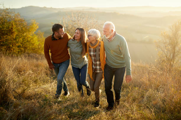istock Happy couples walking up the hill in autumn day. 2194149161