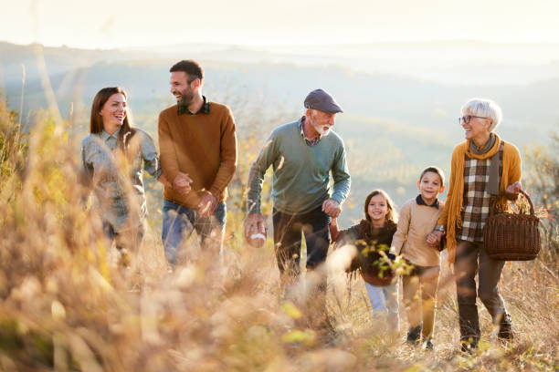 istock Happy multi-generation family going on a picnic in autumn day. 2194149336