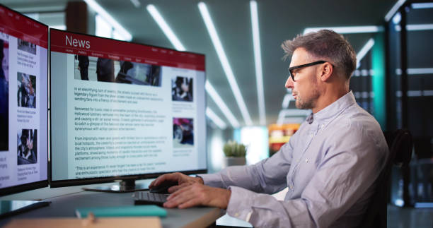 istock Man Looking At News In Online Newspaper 2194154876