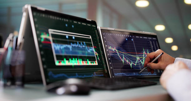 istock Stock Market Broker Looking At Graphs On Multiple Screens 2194155301