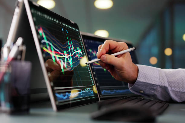 istock Stock Market Broker Looking At Graphs On Multiple Screens 2194155307