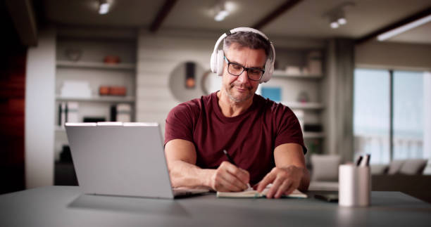 College Teacher At Home Using Laptop