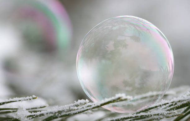 istock A soap bubble shimmers in rainbow colors against a grey background. There is space for text 2194157566