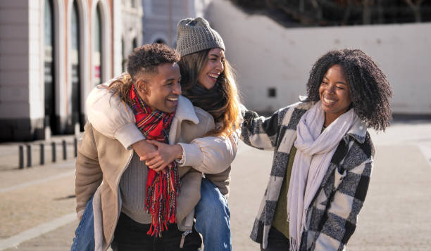 istock Portrait of happy multi-ethnic friends piggybacking and having fun in the city 2194158366