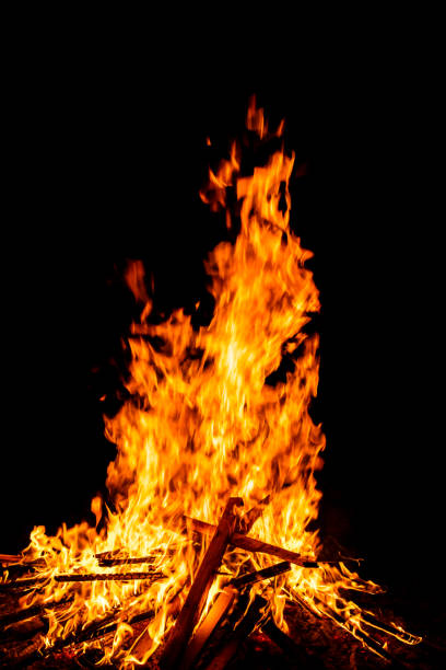 Close-up of a big bonfire on a dark night background. Space for copy.