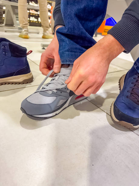 istock male Trying On grey Sneakers at a Shoe Store 2194159984