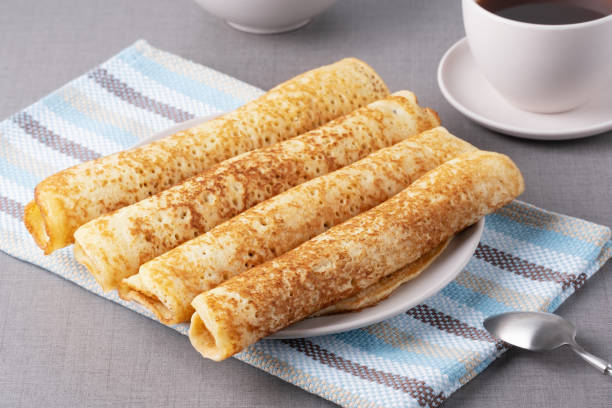 istock Delicious rolled pancakes on a plate on a grey textured surface in a cozy kitchen setting 2194160293