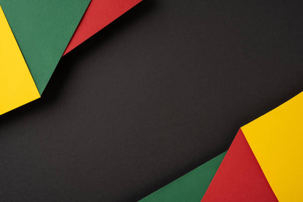 istock Colorful paper textures featuring green, yellow, and red pieces arranged on a black background 2194161613