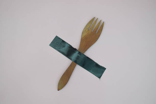 istock Wooden fork crossed out with dark green tape 2194162202