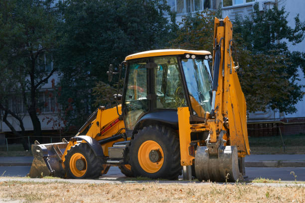 istock A bulldozer with a large bucket stands on an asphalt road 2194164414