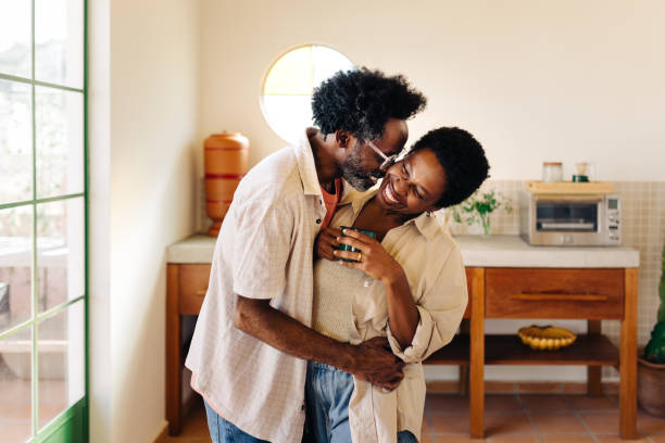 istock Loving couple hugging in the kitchen, sharing a warm cheek kiss 2194165237