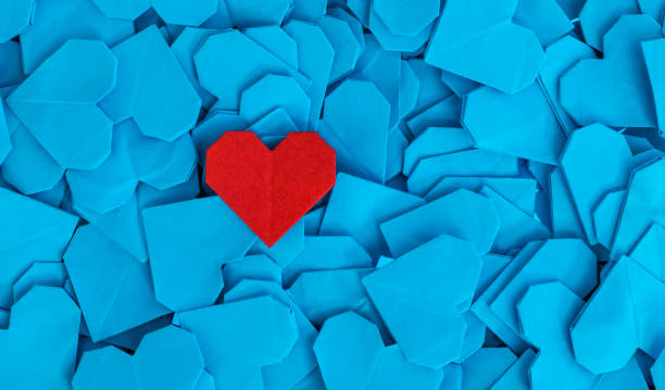 istock Blue origami paper hearts with a red one 2194166476