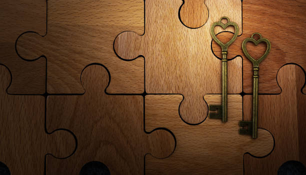istock Two heart shaped antique keys on brown wodden puzzle background 2194166572