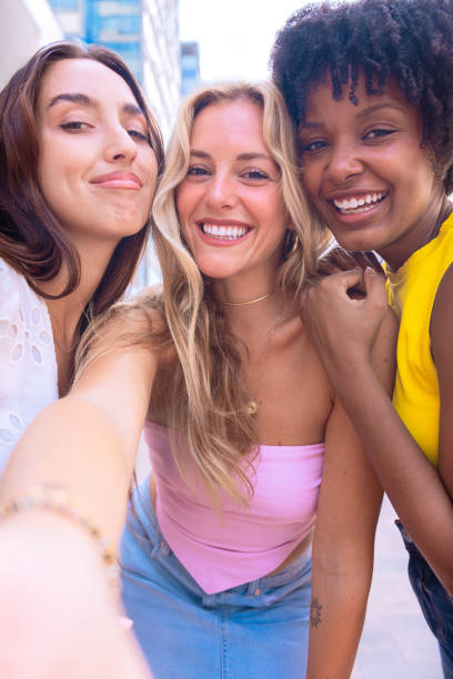 istock Happy friends taking a fun selfie outdoors.Vertical 2194166669