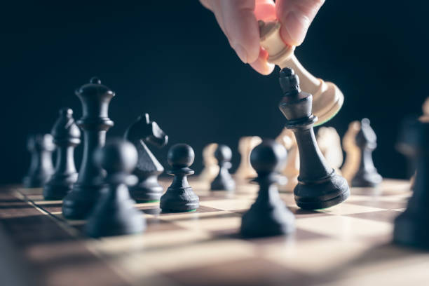 istock Chess pieces on chess board, competition strategy, checkmate, queen takes king to win 2194167793