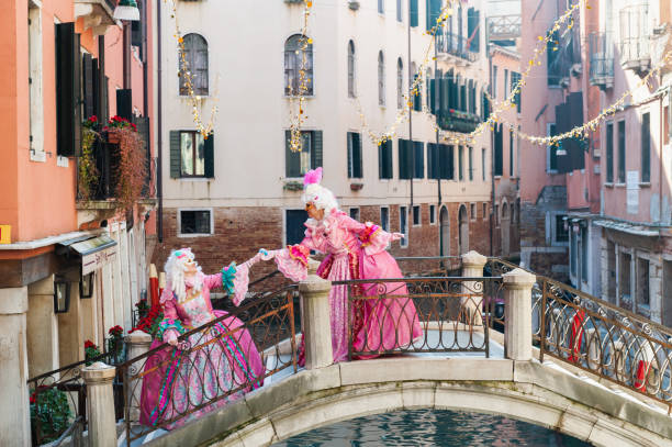 Venice, Italy - February, 14, 2020: Traditional Venice Carnival in Venice, Italy. People wearing masks and colorful costumes at the carnival
