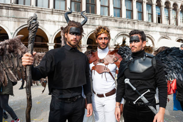 Venice, Italy - February, 16, 2020: Traditional Venice Carnival in Venice, Italy. People wearing masks and colorful costumes at the carnival