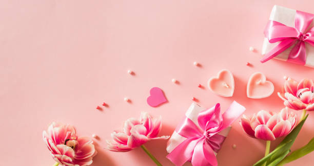 istock Pink tulips and hearts, gift box with ribbon on light pink background 2194170517
