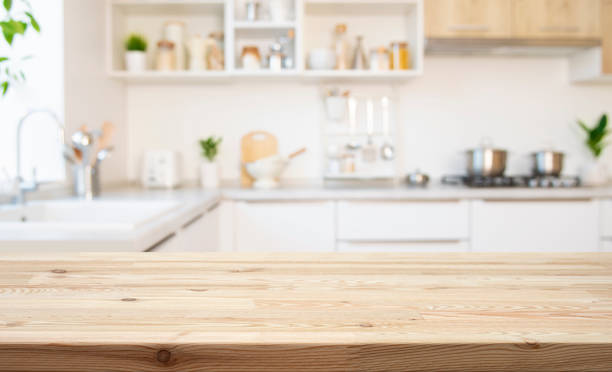 istock Empty wooden table with bright white interior of kitchen as blurred background 2194170523