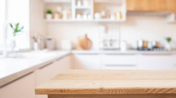 istock Blank wooden table with blur white interior of kitchen as background 2194170524